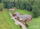 An expansive estate on lush acreage features a custom brick home and detached garage at 720 Miller Chapel Rd, Salisbury, NC 28147