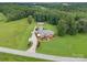 Expansive estate on lush acreage features a brick home, garage and long driveway at 720 Miller Chapel Rd, Salisbury, NC 28147