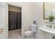 Neutral-toned bathroom boasts a sink, toilet, decorative mirror, and a shower with a gray patterned shower curtain at 720 Miller Chapel Rd, Salisbury, NC 28147