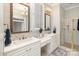 Well-lit bathroom with dual sinks, granite countertops, framed mirrors, and a glass enclosed shower at 720 Miller Chapel Rd, Salisbury, NC 28147