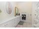 Elegant bathroom features a white vanity with gold accents, a large mirror, and a shower with floral curtains at 720 Miller Chapel Rd, Salisbury, NC 28147