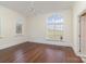 Bright bedroom featuring hardwood floors, a ceiling fan, and large windows providing natural light at 720 Miller Chapel Rd, Salisbury, NC 28147