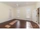 This comfortable bedroom is bright and spacious with windows and dark hardwood flooring at 720 Miller Chapel Rd, Salisbury, NC 28147