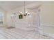 Sunlit dining room featuring large windows with shutter, tile flooring, and contemporary chandelier at 720 Miller Chapel Rd, Salisbury, NC 28147