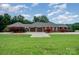 Spacious home exterior featuring a three car garage, large front lawn and manicured landscaping at 720 Miller Chapel Rd, Salisbury, NC 28147