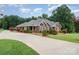 Exterior view of brick home, showcasing the long driveway and beautiful landscaping at 720 Miller Chapel Rd, Salisbury, NC 28147