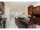 Kitchen island with granite countertops, black appliances, tile flooring, and an open floor plan at 720 Miller Chapel Rd, Salisbury, NC 28147