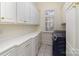 Functional laundry room equipped with modern washer, a window, and plenty of cabinets for storage at 720 Miller Chapel Rd, Salisbury, NC 28147