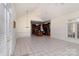 Open living area featuring tile flooring, large windows, neutral walls, and access to the kitchen at 720 Miller Chapel Rd, Salisbury, NC 28147