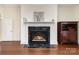 Living room with marble fireplace with wooden cabinets, hardwood floors, and neutral paint color at 720 Miller Chapel Rd, Salisbury, NC 28147