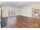 Bright living room showcasing hardwood floors, a cozy fireplace, and French doors leading to a patio at 720 Miller Chapel Rd, Salisbury, NC 28147