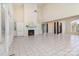 Bright living area featuring tile flooring, high ceiling, a fireplace, and decorative pillars at 720 Miller Chapel Rd, Salisbury, NC 28147