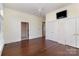 Spacious main bedroom features hardwood floors, a ceiling fan, a television, and access to the main bathroom at 720 Miller Chapel Rd, Salisbury, NC 28147