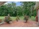 Relaxing brick patio with manicured lawn and three planters full of colorful flowers and greenery at 720 Miller Chapel Rd, Salisbury, NC 28147