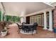 Outdoor patio with brick flooring, circular dining table, surrounded by white pillars and lush landscaping at 720 Miller Chapel Rd, Salisbury, NC 28147