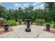 Well-maintained outdoor space with concrete flooring, ornate fountain, trimmed bushes, and verdant green grass at 720 Miller Chapel Rd, Salisbury, NC 28147