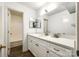 Bathroom with a large mirror, a white countertop with cabinets, and a bathtub at 7026 Quail Hill Rd, Charlotte, NC 28210