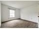 A bright bedroom with a large window and wood-look flooring at 7026 Quail Hill Rd, Charlotte, NC 28210