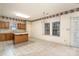 Kitchen with oak cabinets, tile countertops, and breakfast bar at 9318 Lake Spring Ave, Charlotte, NC 28216