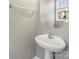 Small bathroom with pedestal sink and octagonal mirror at 9718 Waltham Ct, Charlotte, NC 28269