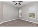 A bedroom features two windows and a lighted ceiling fan at 2009 Atherton Dr, Indian Trail, NC 28079