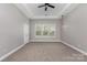 A spacious bedroom features neutral paint, plush carpet, and a lighted ceiling fan at 2009 Atherton Dr, Indian Trail, NC 28079