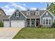 Charming home with a two-car garage, welcoming entrance, and lush green lawn at 2009 Atherton Dr, Indian Trail, NC 28079