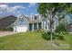 Charming home with a three-car garage, beautiful green lawn, and mature trees at 2009 Atherton Dr, Indian Trail, NC 28079