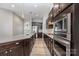 Well-equipped kitchen with stainless steel appliances, dark cabinets, and wood flooring at 2009 Atherton Dr, Indian Trail, NC 28079