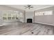 Bright living room features a fireplace, large windows, and wood flooring at 2009 Atherton Dr, Indian Trail, NC 28079