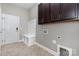 A well-lit mudroom features a convenient storage bench, coat hooks, and upper cabinets at 2009 Atherton Dr, Indian Trail, NC 28079