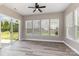 Bright sun room with a ceiling fan, large windows with a view of the backyard at 2009 Atherton Dr, Indian Trail, NC 28079