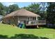 Home exterior with a spacious deck, landscaped yard, and natural setting at 436 E Oakwood Ave, Albemarle, NC 28001