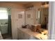 Bathroom featuring tiled walls, vanity with sink, and a glimpse into the shower area at 436 E Oakwood Ave, Albemarle, NC 28001