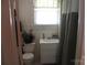 Compact bathroom with a toilet, vanity sink, and shower with curtain at 436 E Oakwood Ave, Albemarle, NC 28001