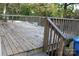 Large wooden deck with railing and fallen leaves scattered on the floor at 436 E Oakwood Ave, Albemarle, NC 28001
