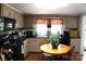 Traditional kitchen featuring appliances and a small breakfast nook with wood table and chairs at 436 E Oakwood Ave, Albemarle, NC 28001