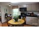 Charming kitchen with wooden table, appliances, and cozy window at 436 E Oakwood Ave, Albemarle, NC 28001