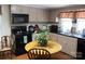 Functional kitchen with appliances, dark countertops and a wooden table, perfect for cooking at 436 E Oakwood Ave, Albemarle, NC 28001