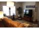 Cozy living room with sofa, large TV, side table and natural light from multiple windows at 436 E Oakwood Ave, Albemarle, NC 28001