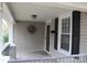 Inviting front porch features stone-accented columns, a wreath, and a storm door at 436 E Oakwood Ave, Albemarle, NC 28001