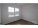 Simple bedroom with hardwood floors and large windows at 10108 Whitaker Pointe Dr, Huntersville, NC 28078