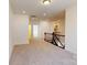 Carpeted bedroom with bright natural light and staircase entry at 10108 Whitaker Pointe Dr, Huntersville, NC 28078