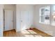 Cozy bedroom featuring hardwood floors, neutral paint, and a bright window at 10108 Whitaker Pointe Dr, Huntersville, NC 28078