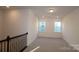 Bright bonus room with neutral carpeting and two windows at 10108 Whitaker Pointe Dr, Huntersville, NC 28078