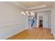 Open dining area adjacent to the staircase and kitchen, featuring modern lighting and hardwood floors at 10108 Whitaker Pointe Dr, Huntersville, NC 28078