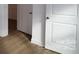 Bright hallway with hardwood floors and white doors at 10108 Whitaker Pointe Dr, Huntersville, NC 28078