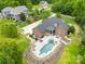 Aerial view of a brick home with a pool, lush landscaping, patio area, and a large backyard at 112 Berea Baptist Church Rd, Stanfield, NC 28163