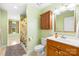 Bathroom with an extended vanity and shower with patterned curtain at 112 Berea Baptist Church Rd, Stanfield, NC 28163