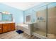 Well-lit bathroom features a soaking tub, glass shower and a wood vanity at 112 Berea Baptist Church Rd, Stanfield, NC 28163